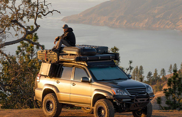 man sitting on top of SUV