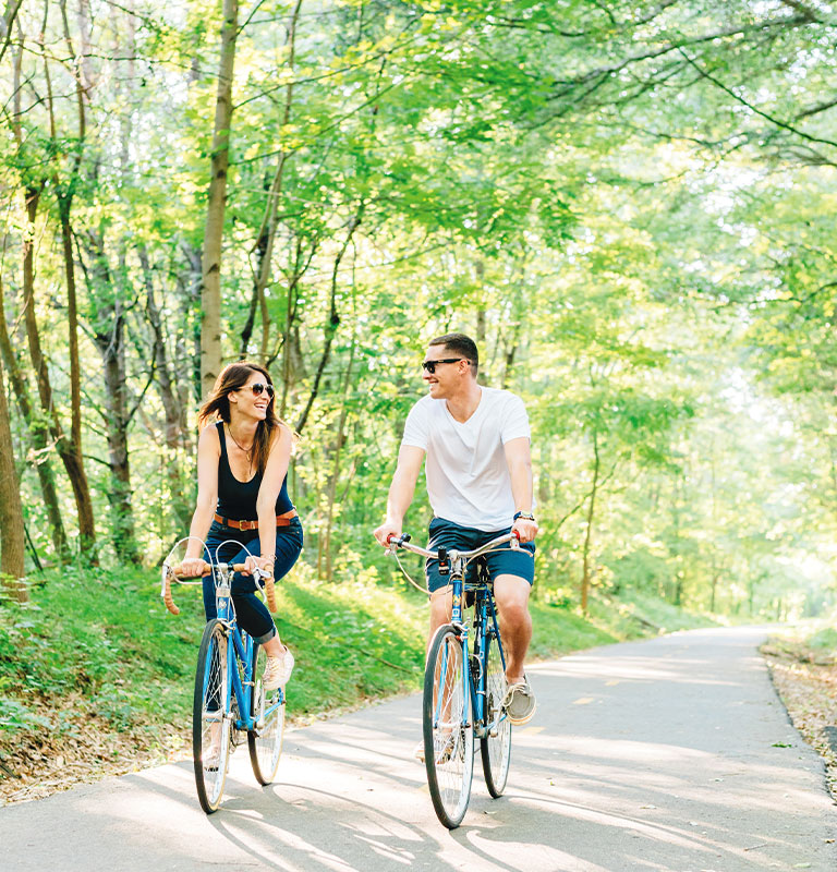 couple riding bikes on Swamp Rabbit Trail