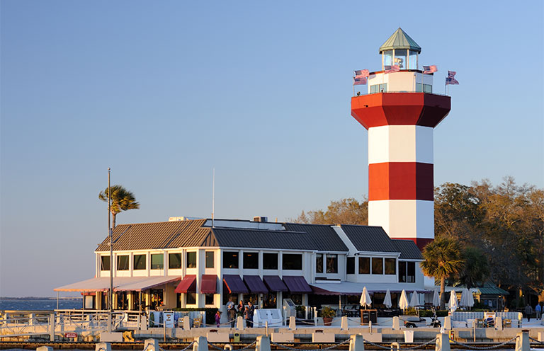 Hilton Head lighthouse with people out or inside the restaurant, quarterdeck restaurant
