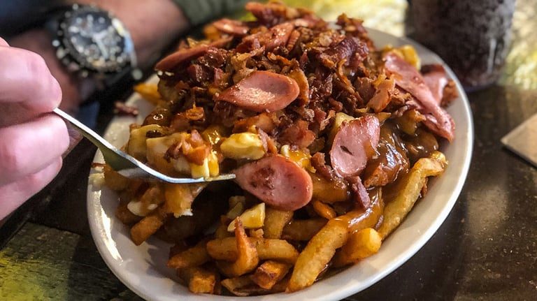 Eating Sausage Poutine in Quebec, Canada. Credit: Katherine Scherdel