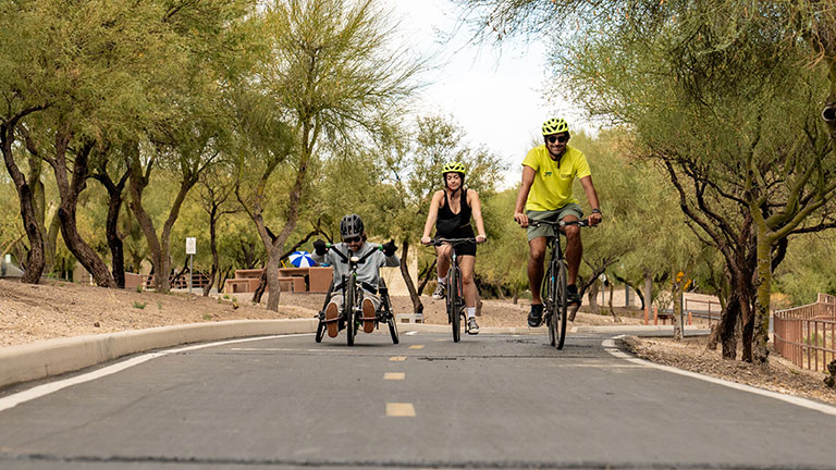 Cyclists ride along The Loop, Tucson’s 131-mile network of paved biking and walking paths; photo courtesy of Visit Tucson