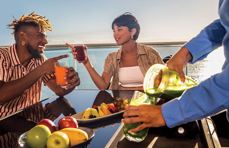 man and woman having drinks and fruit