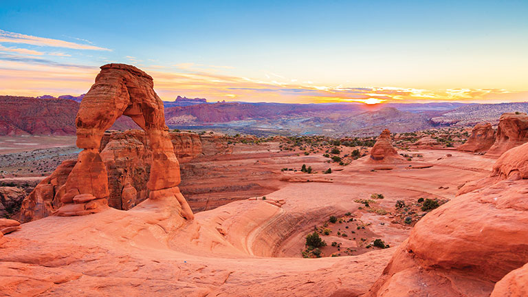 Delicate Arch at sunset in Arches National Park, Utah; photo courtesy of Adobe Stock.