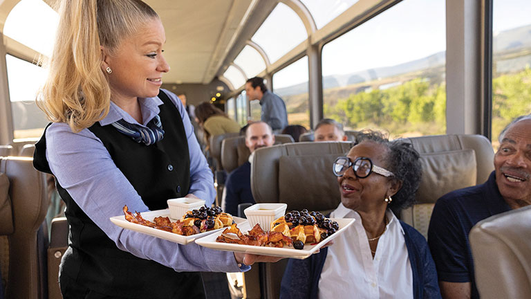 Onboard meal service aboard a luxury train journey; photo courtesy of Rocky Mountaineer.