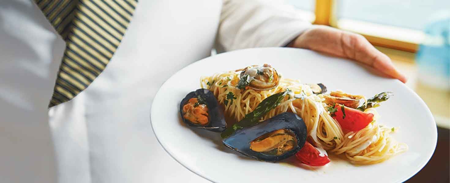 Chef presenting meal of clams casino