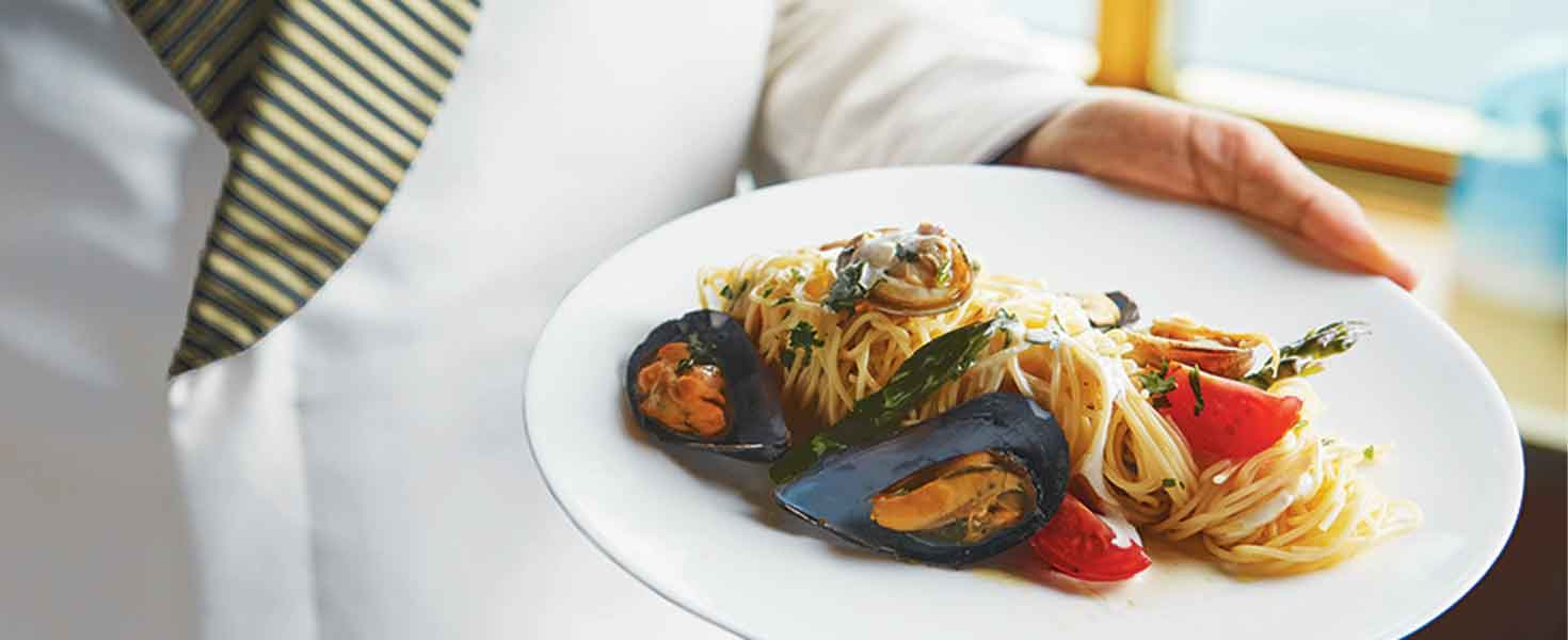 Chef presenting meal of clams casino