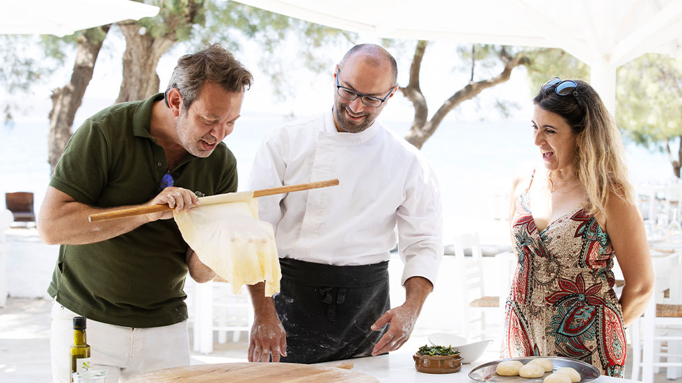 man and woman in cooking class with chef