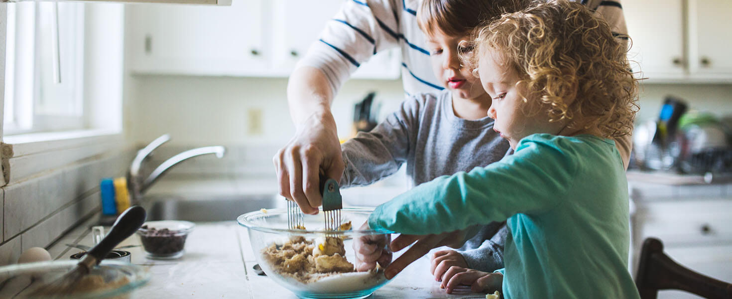 Kids making cookies with an adult