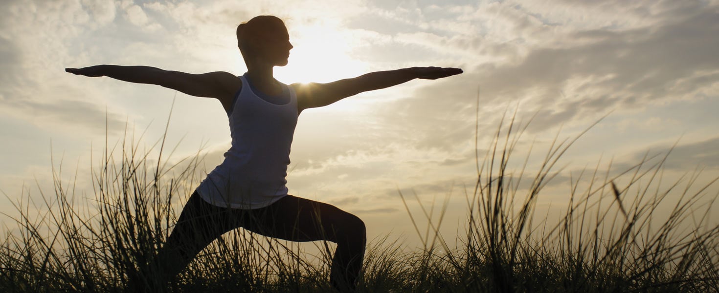 Woman doing a yoga pose outside
