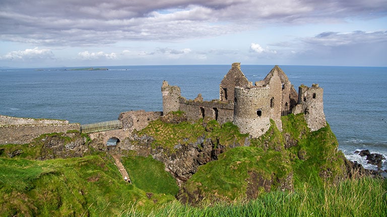 Ruins of the medieval Dunluce Castle along the rugged coast of County Antrim in Northern Ireland