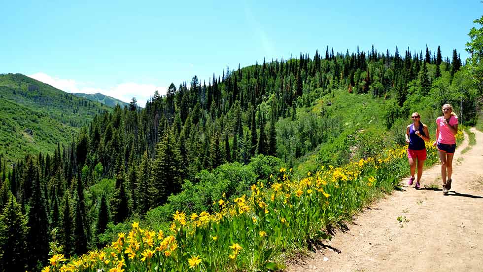 The girls are jogging along Spring Creek Trail in Steamboat Springs, Colorado.