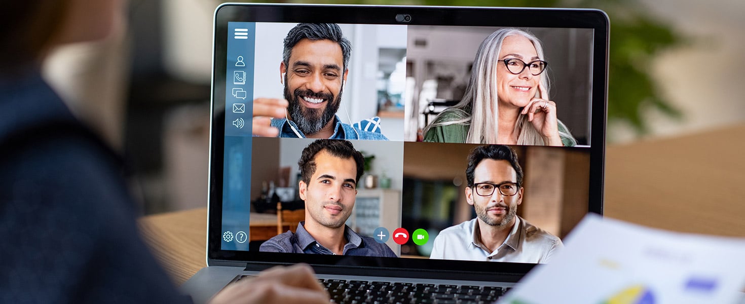 Back view of business woman talking to her colleagues about business plan in video conference.