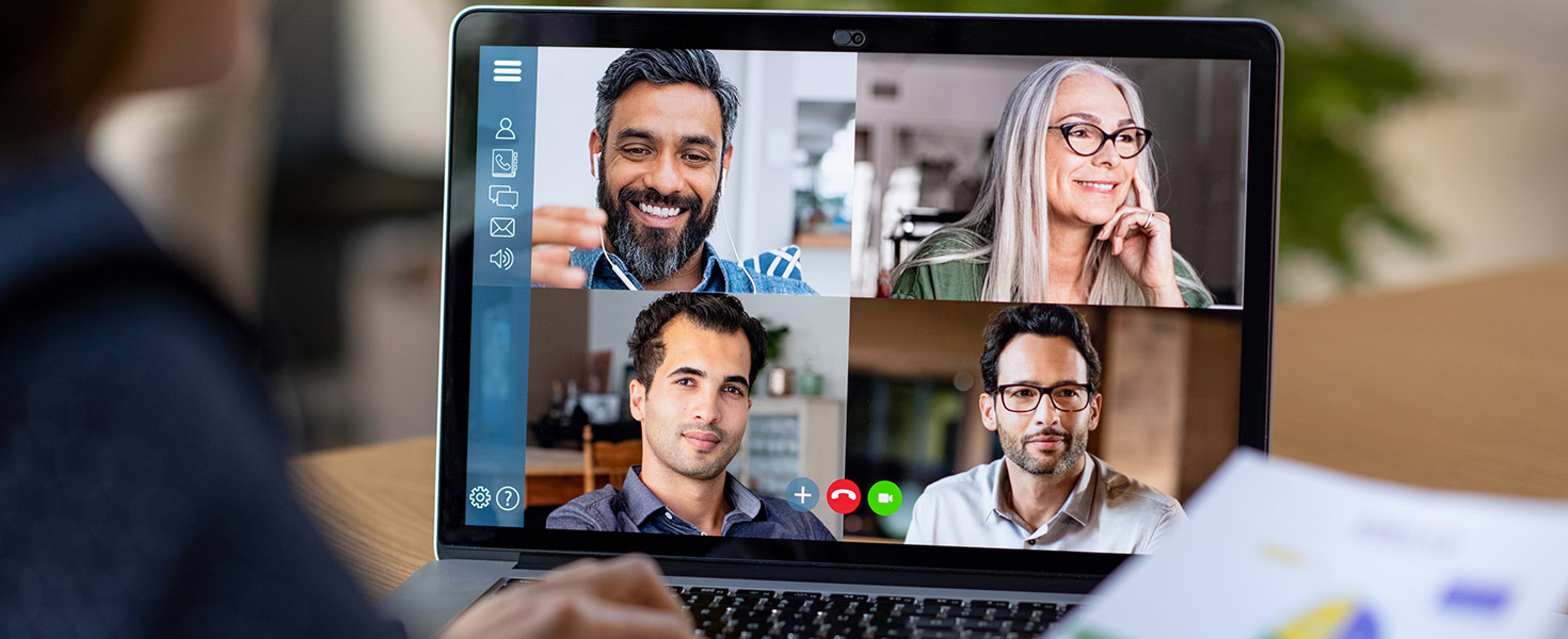 Back view of business woman talking to her colleagues about business plan in video conference.