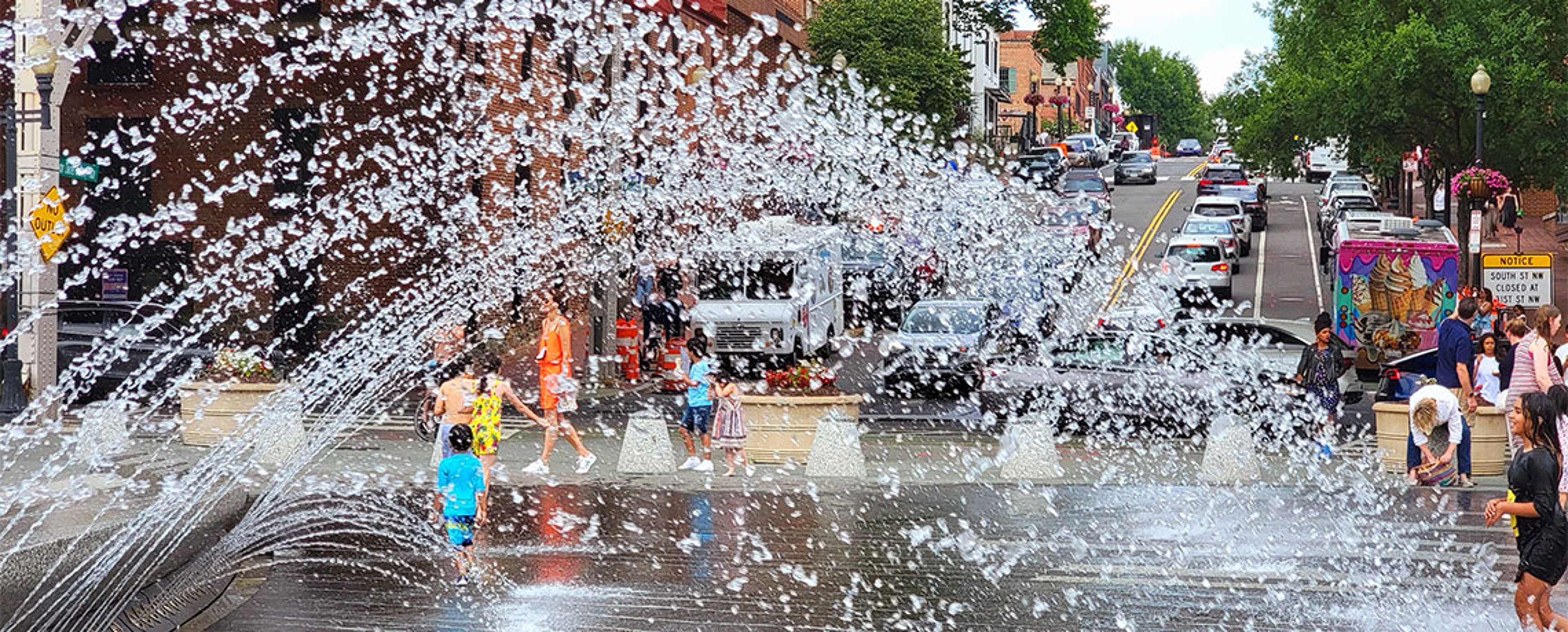 Children play in the fountain in Washington, DC's Georgetown Waterfront Park