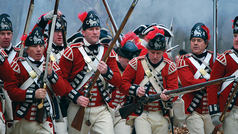 Reenactment of British light infantry under fire at Minute Man National Historical Park; photo courtesy of NPS