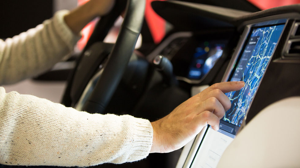 person using navigation system in car