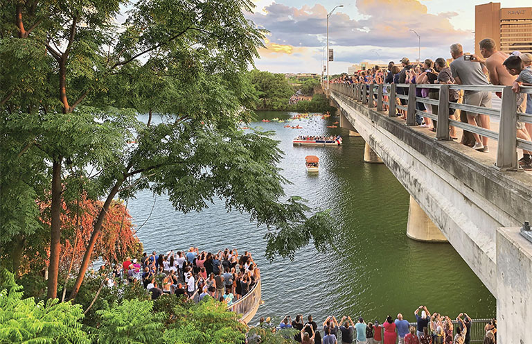 Crowds gather at Congress Avenue Bridge to watch the bats take flight