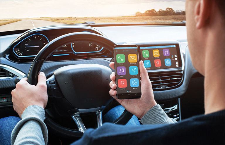 man connecting phone to car