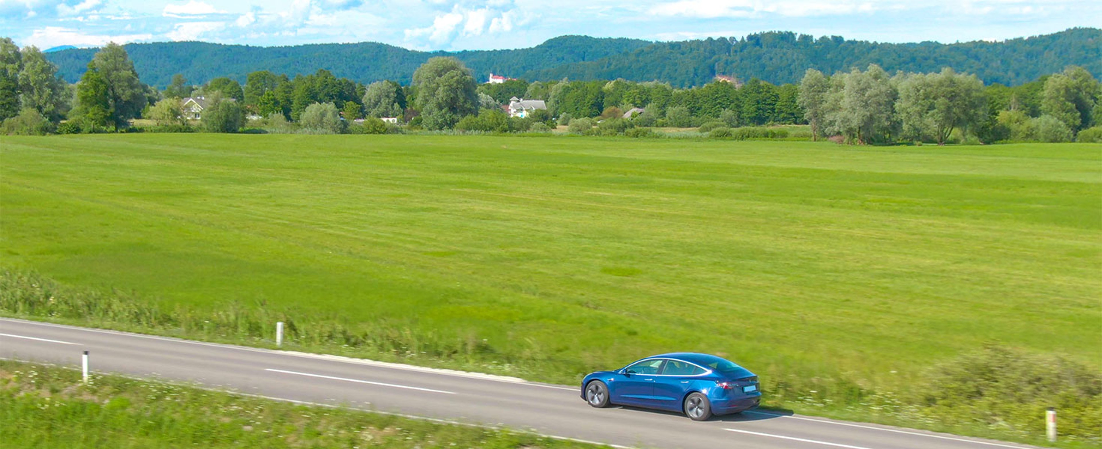 Tesla driving on country road
