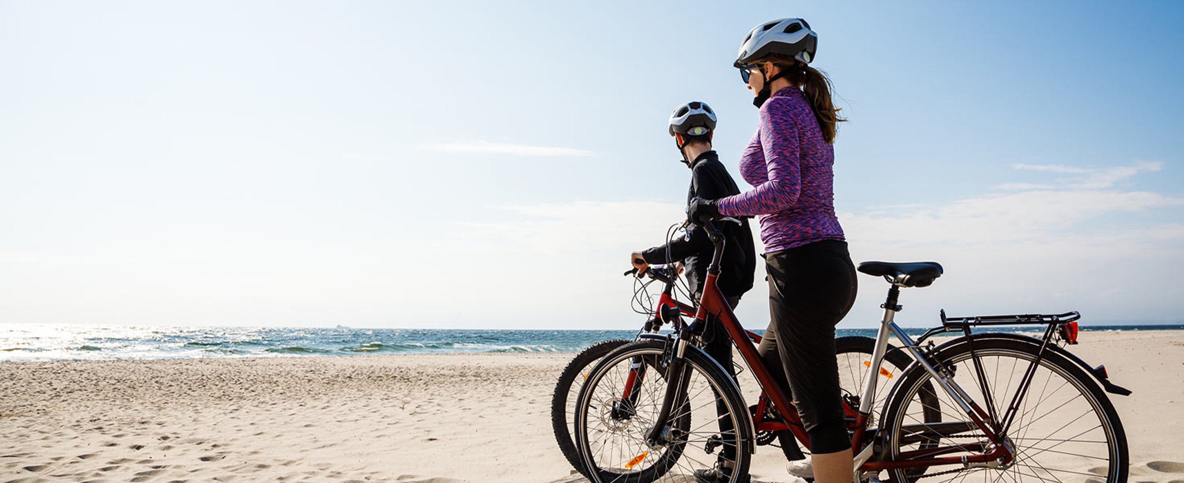 Couple biking on the beach