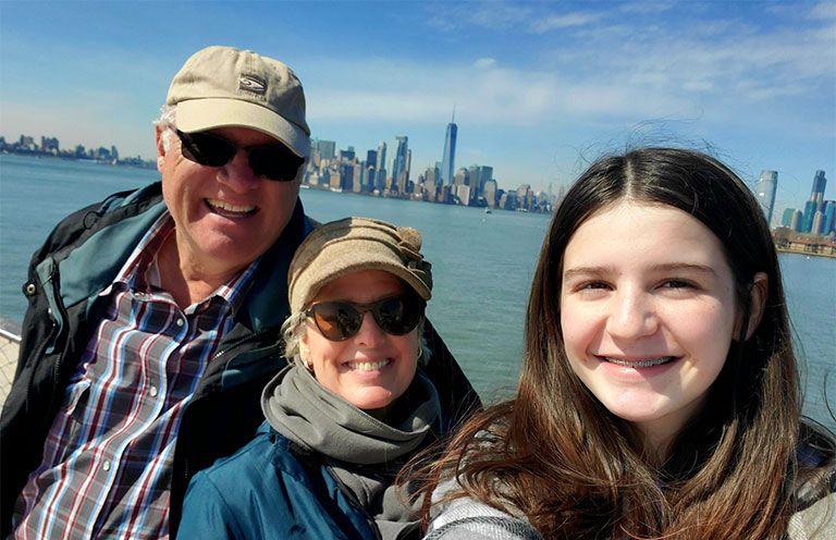girl, man, and woman in front of New York City skyline