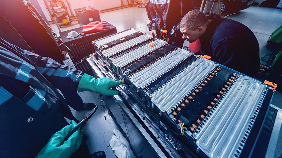 working on an electric motor of an electric vehicle 