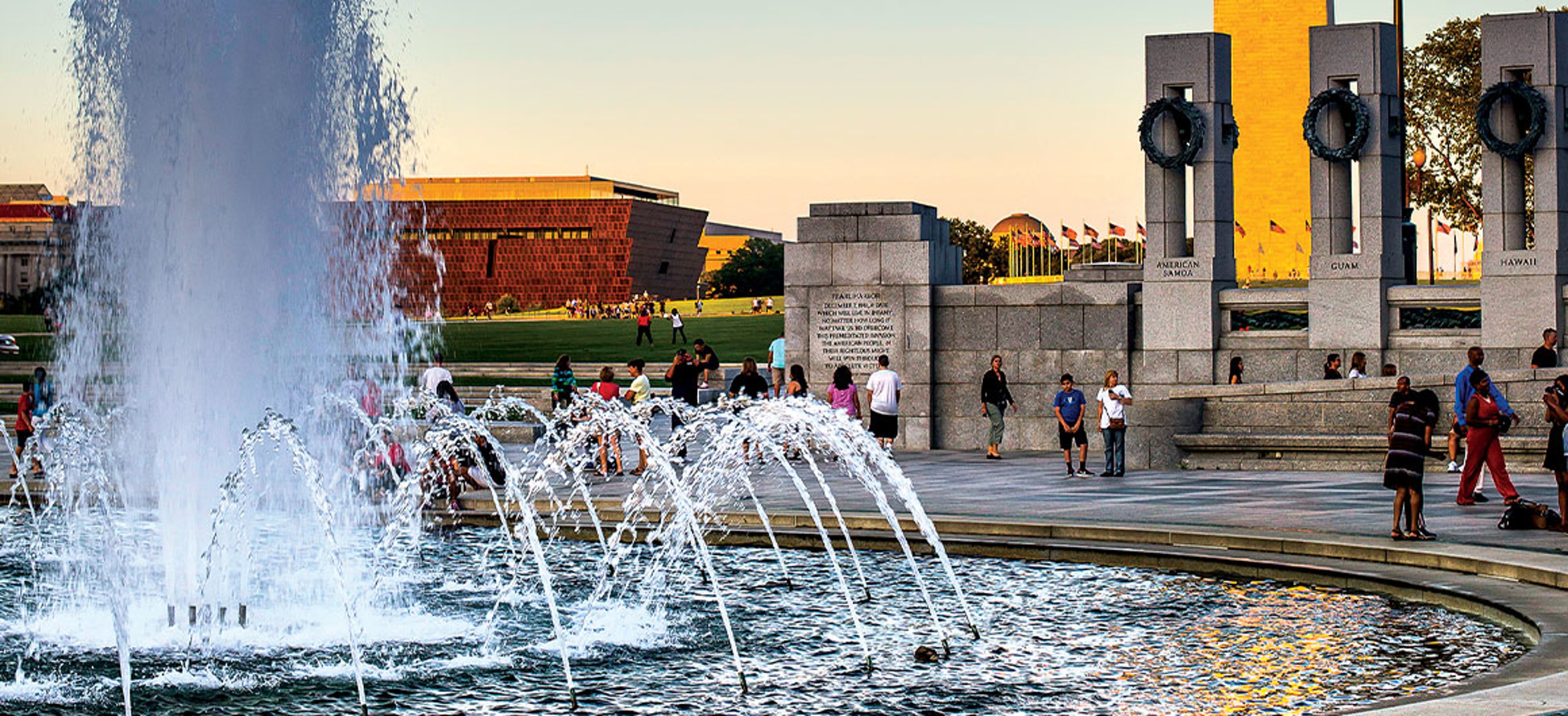The World War II Memorial, with the Washington Monument and the National Museum of African American History AAA.com/The-Extra-Mile-Magazine and Culture seen in the background