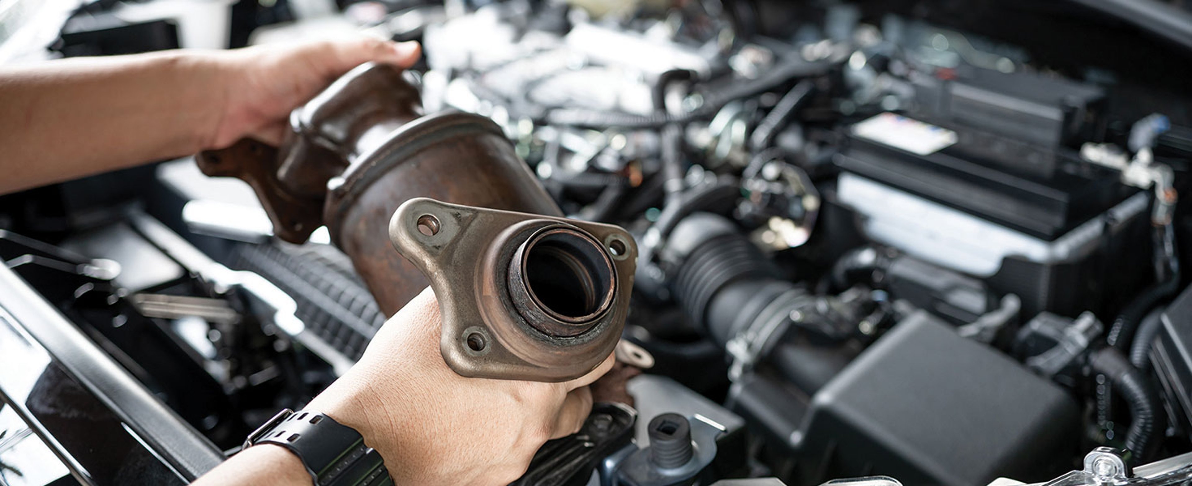 person holding catalytic converter