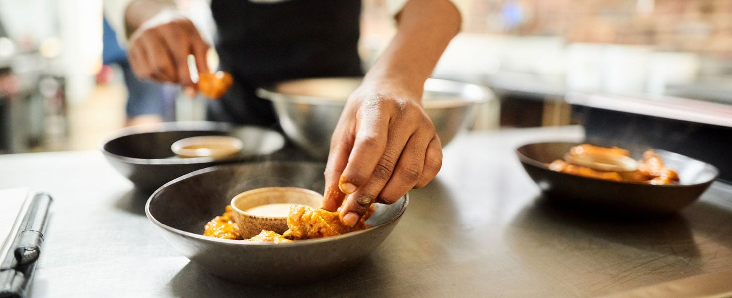 Chef in kitchen prepping food
