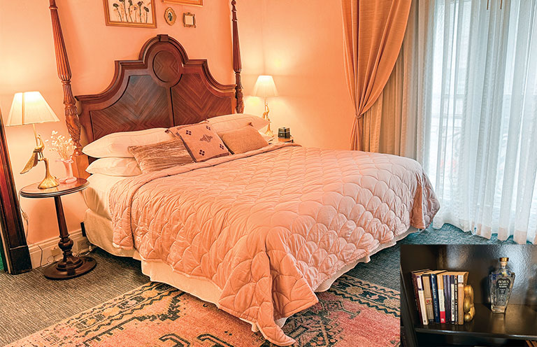 Gatsby suite at Seelbach Hotel, bed in pink bedding and insert of books and bourbon offered at the suite