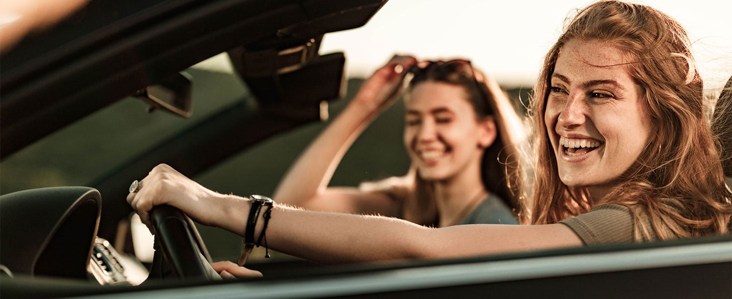 two women driving in convertible car