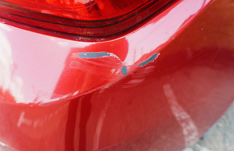 red car bumper scratch