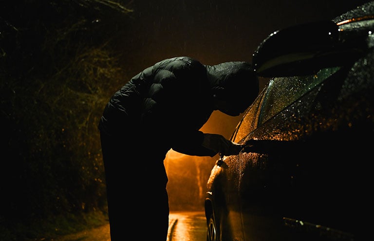 person breaking into car