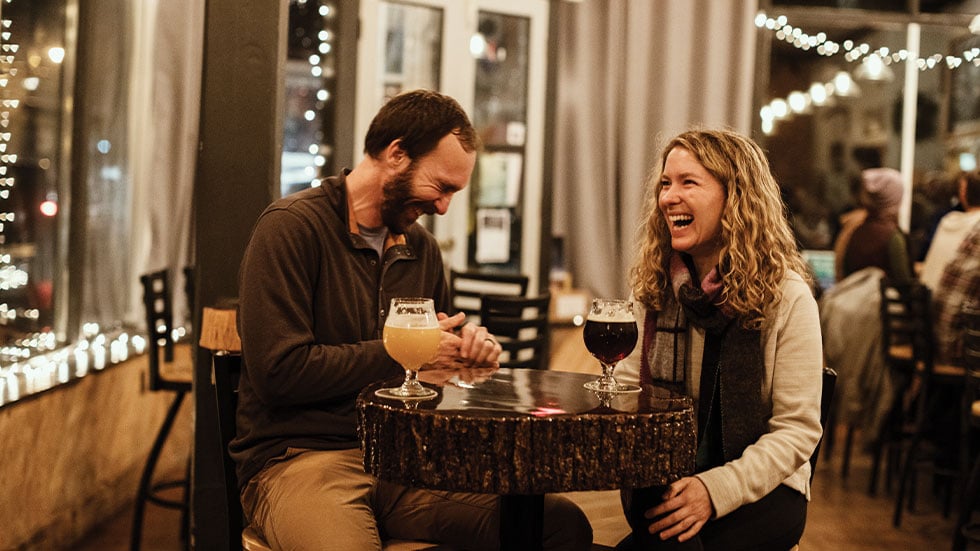 man and woman having drinks at restaurant