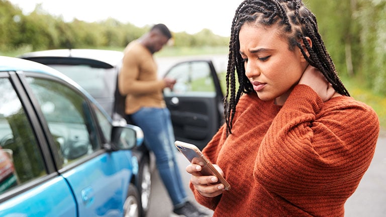 Female Motorist Involved In Car Accident Calling Insurance Company Or Recovery Service By Monkey Business