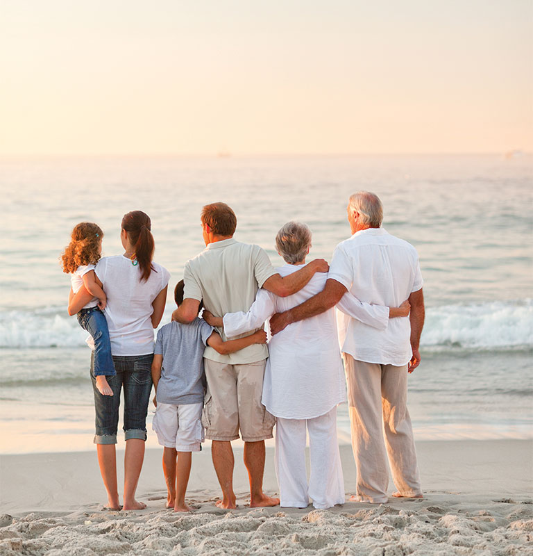 grandparents, parents, and kids looking out at beach