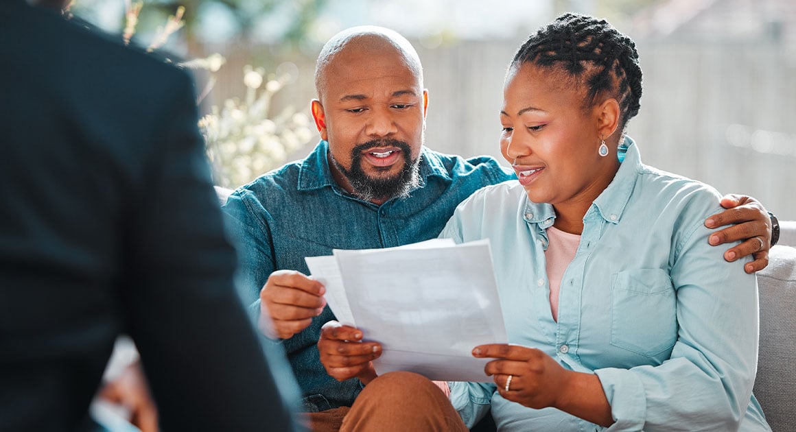 man and woman looking at documents