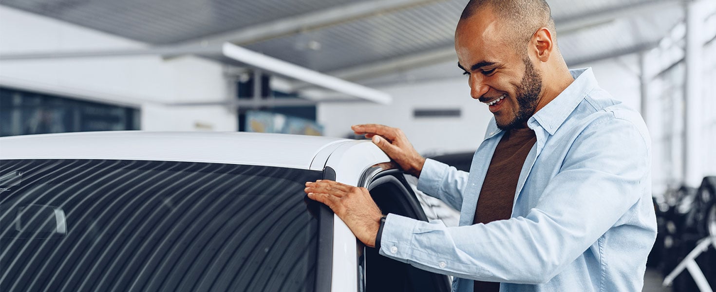 Man looking at new car