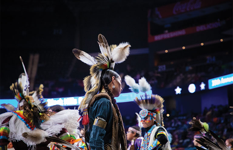 people wearing Regalia during a powwow