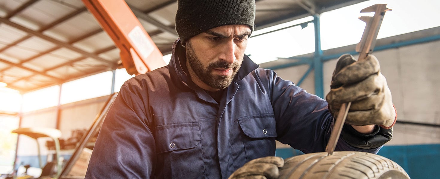 Man working on tires. Photo by Riccardo Piccinini/Stock.Adobe.com