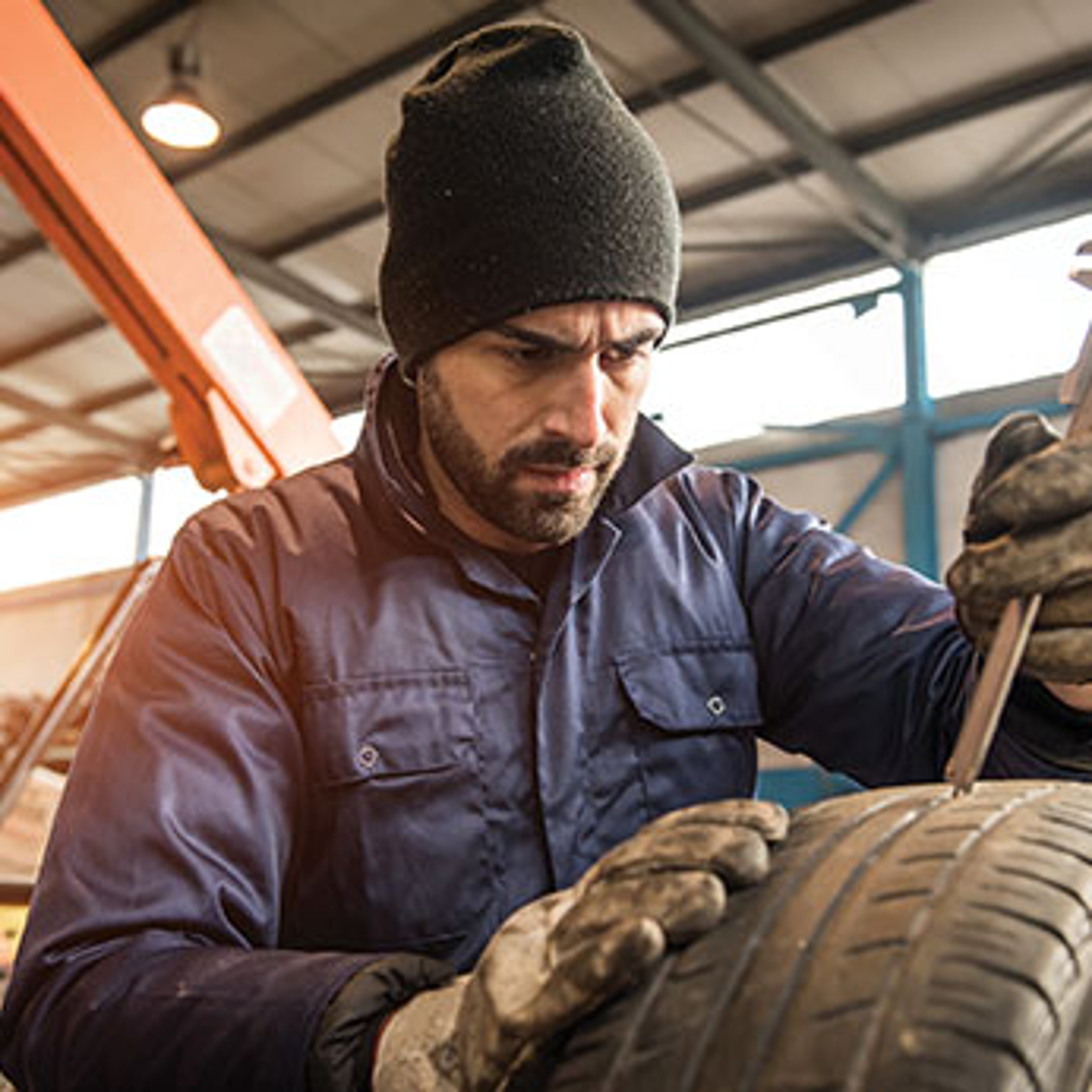 Man working on tires. Photo by Riccardo Piccinini/Stock.Adobe.com