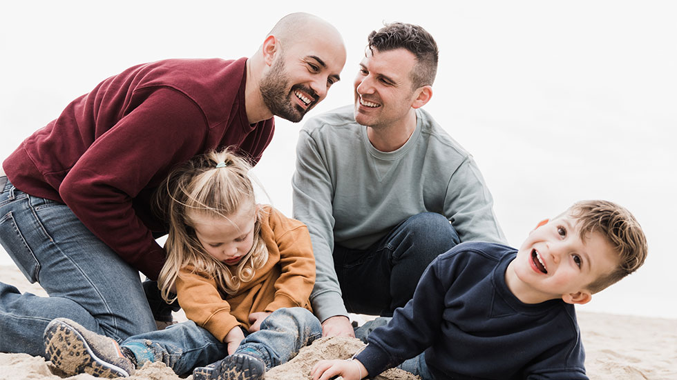 family playing in sand