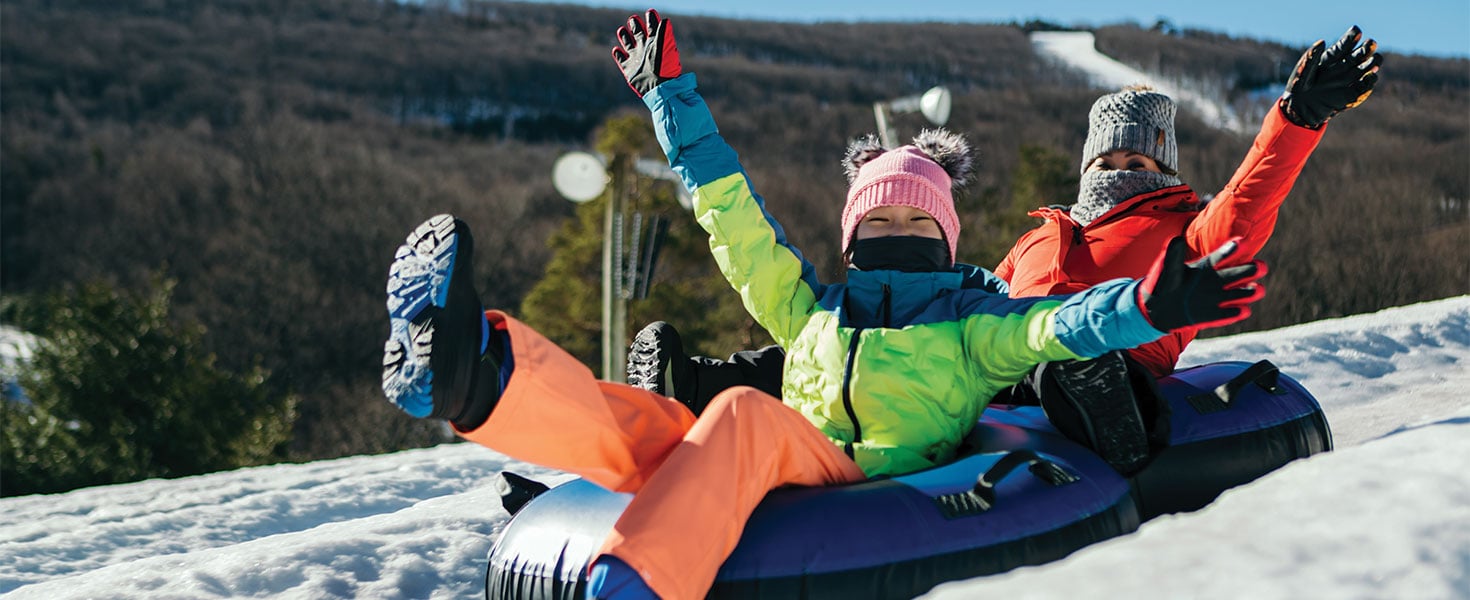 People snow tubing at Camelback Resort