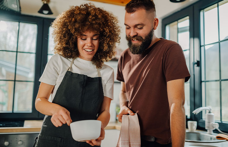 man and woman cooking in kitchen
