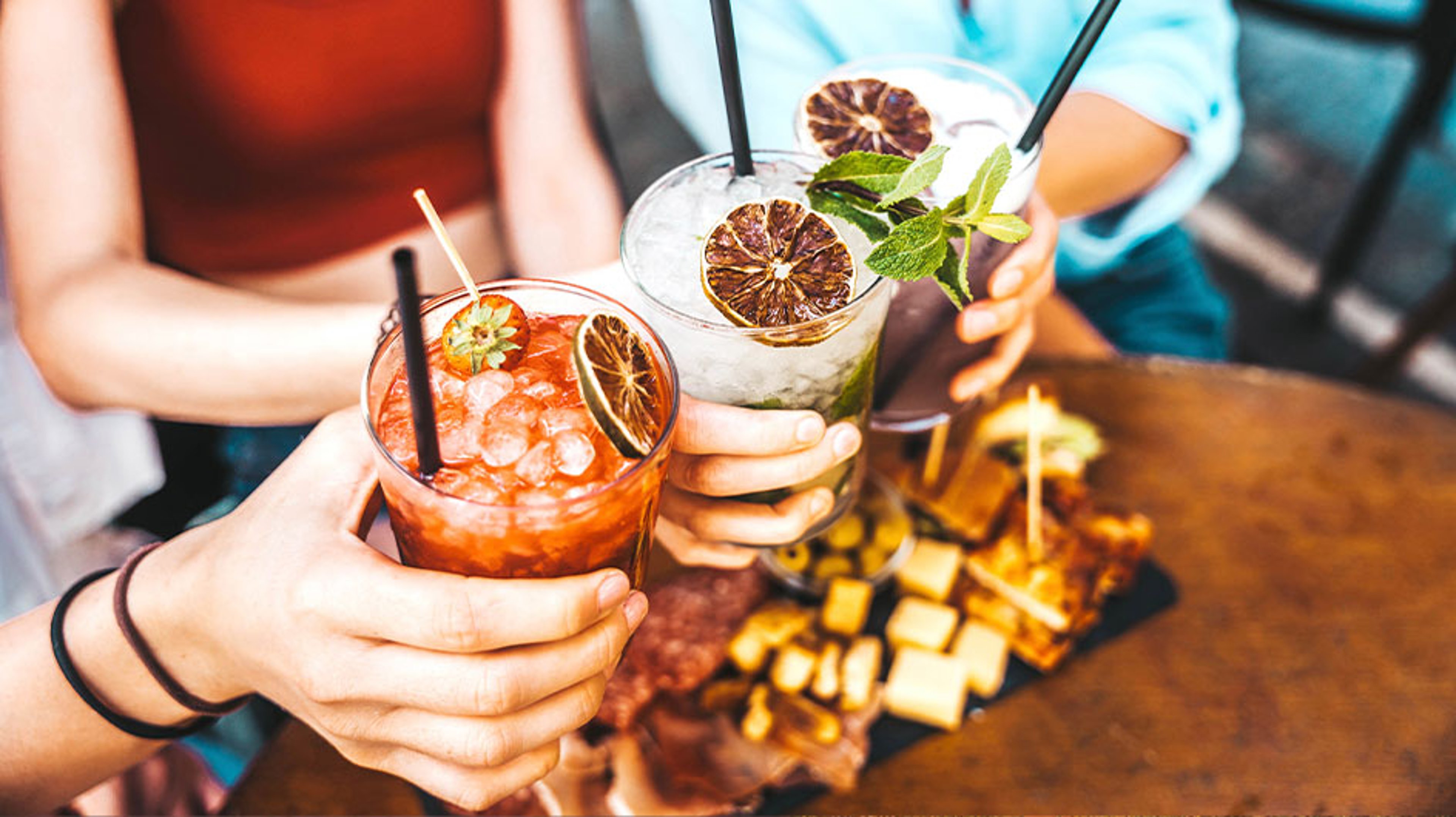 people making toast with mocktails