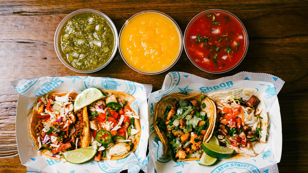 assortment of tacos and birria on table