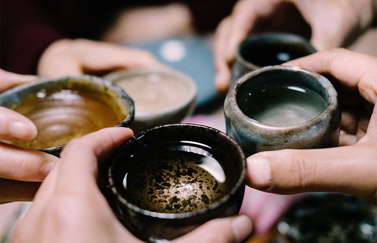 People toasting with Sake