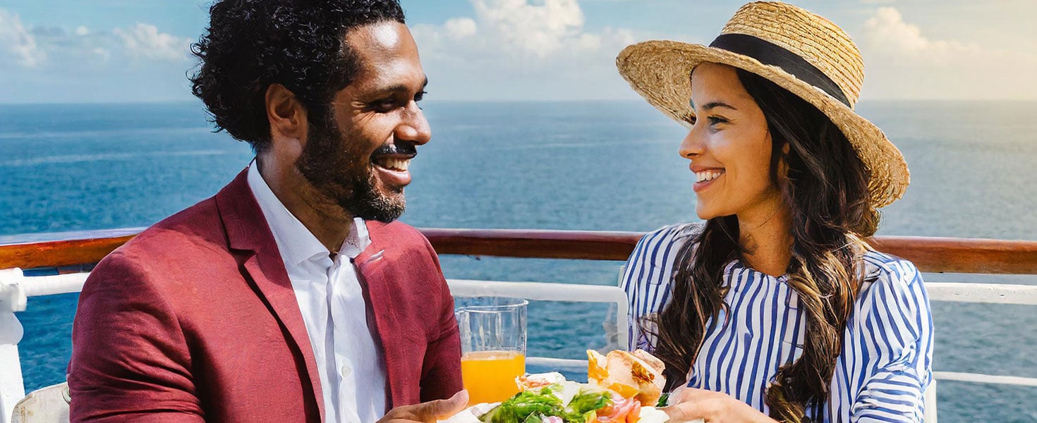 man and woman eating on a cruise ship