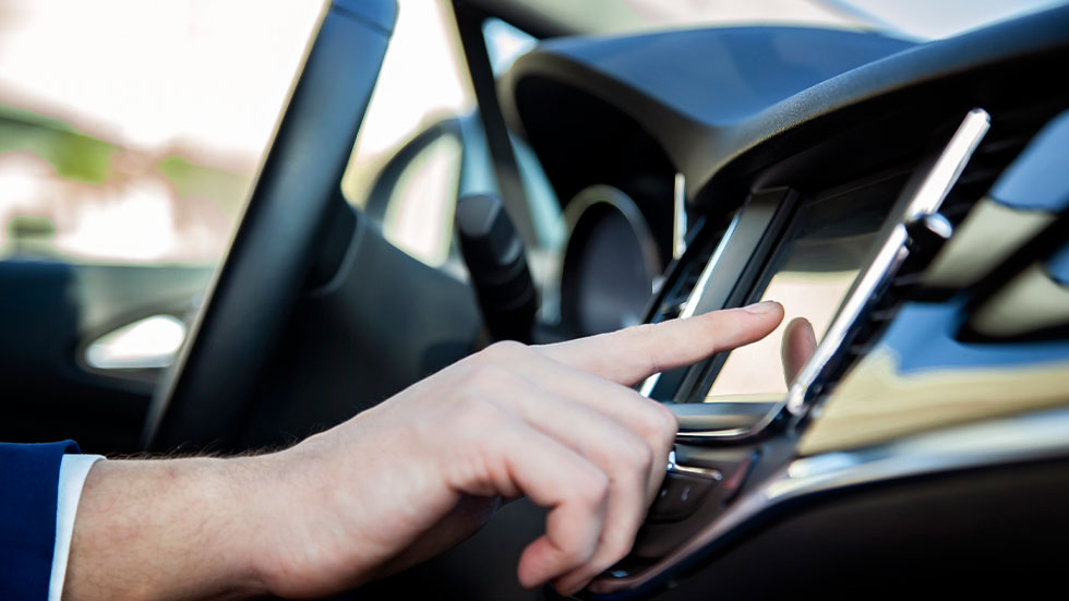 Man Touching Car Dashboard