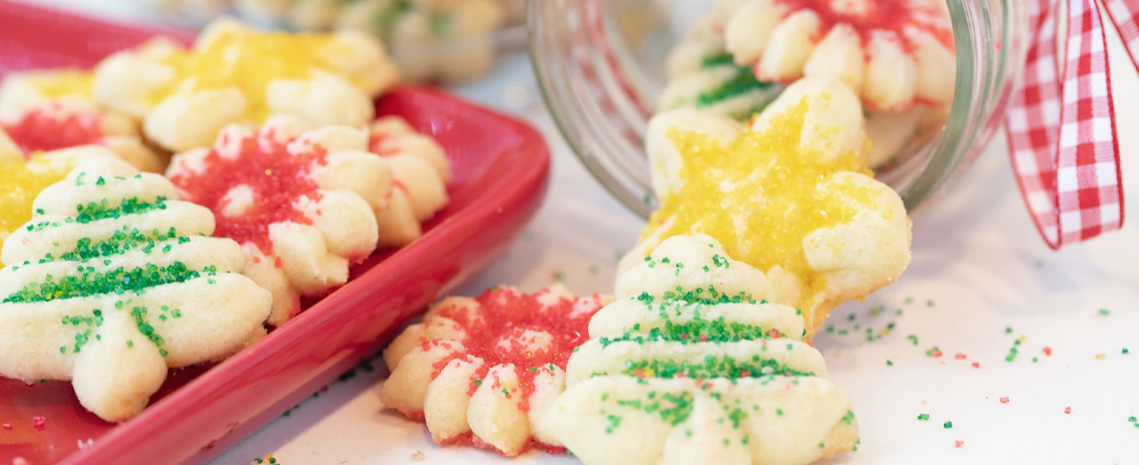 Holiday Spritz Cookies falling out of Mason Jar